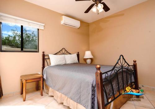 a bedroom with a bed and a fan and a window at Luxury 4-Bedroom San Felipe Vacation Rental in San Felipe