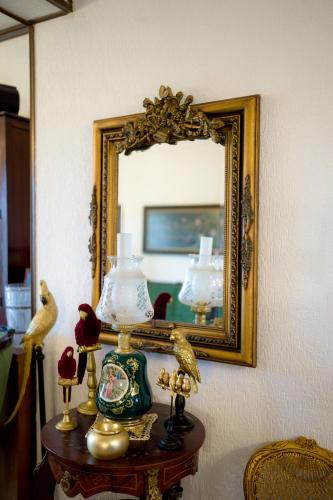 a table with a mirror and some lamps on it at Archontiko Alexandros Luxury Suites in Kardiá