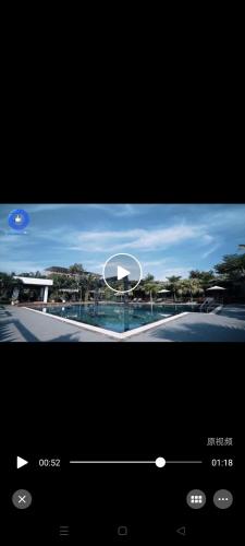 a television screen with a picture of a pool at Twin Palms Resort in Sihanoukville