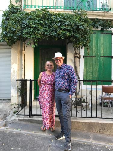 a man and a woman standing in front of a gate at Byhus - det genuina Frankrike in Laurens