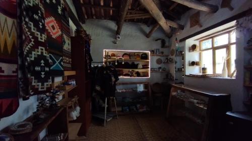 a room with a shelf with shoes in it at PONDOWASI LODGE in Ibarra