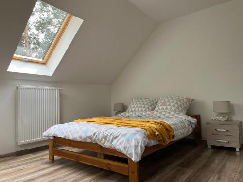 a bedroom with a bed and a window at Las i Staw Roztocze in Wólka Łosiniecka