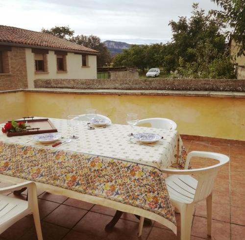 una mesa con 2 sillas y un mantel en el balcón en Casa Luka Etxea, en Zábal