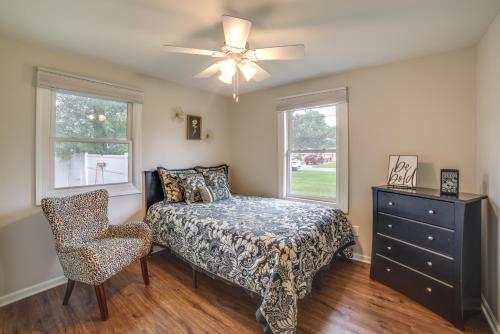Schlafzimmer mit einem Bett, einem Stuhl und Fenstern in der Unterkunft Lakefront Portage Home 3 Mi to Lake Michigan! in Portage