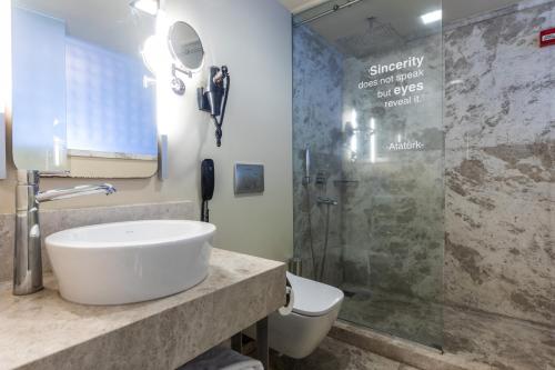 a bathroom with a sink and a shower at Ramada By Wyndham Istanbul Pera Taksim in Istanbul