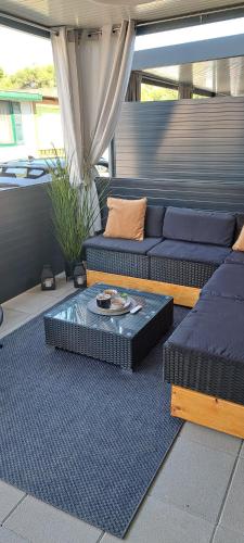 a living room with couches and a coffee table at Mobilna kućica 146 Harmony in Privlaka
