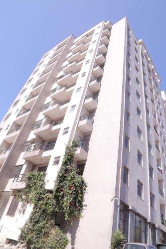 a tall white building with plants on it at Matts Realestate in Addis Ababa