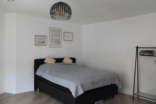 a bedroom with a bed in a white room at Soester Altstadt Apartment in Soest