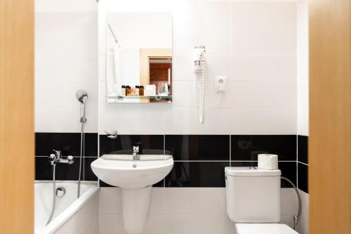 a bathroom with a toilet and a sink at Hotel Polana in Zvolen