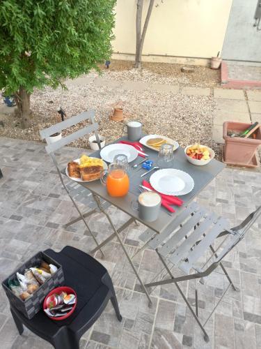 a table with food and orange juice on it at Bed&Breakfast Villa Nora in Quartu SantʼElena