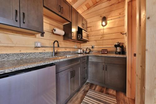 a kitchen with wooden walls and stainless steel appliances at Pet Friendly Cabins in Hanksville Utah in Hanksville