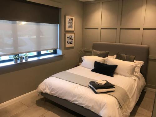 a bedroom with a large bed with a window at Modern Annex in Kent