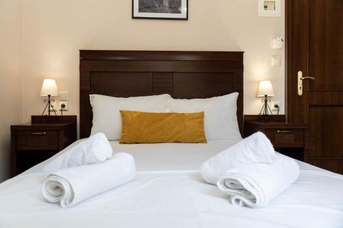 a bedroom with a bed with towels on it at Spilaio at Meteora in Kalabaka