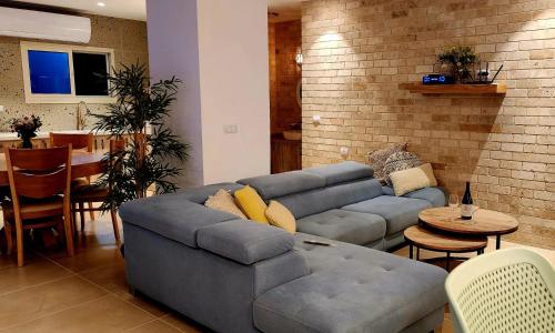 a living room with a couch and a table at Serentias suite & spa in Ein Kinya
