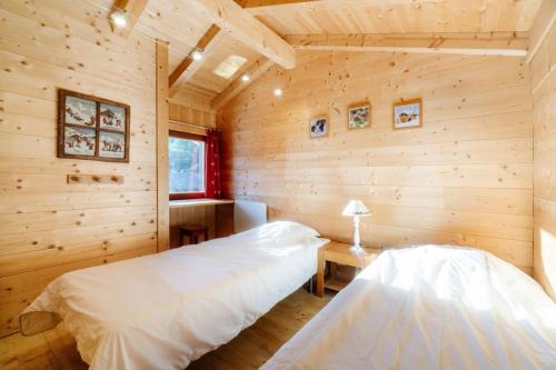 Dormitorio en cabaña de madera con cama y escritorio en La turra, en Lanslebourg-Mont-Cenis