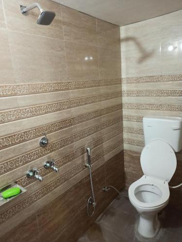 a bathroom with a toilet and a shower at Hari Kripa Sadan in Ayodhya