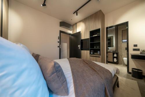 a bedroom with a large bed and a bathroom at VELVET rooms & more in Zadar