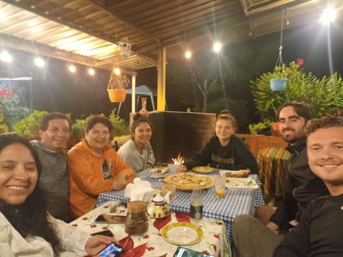 a group of people sitting around a table eating at Green Bamboo Lodge in San Francisco de Borja