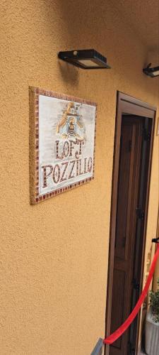 a sign on the side of a building at Loft Pozzillo in Monreale
