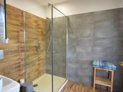 a shower with a glass door in a bathroom at Cottage by the lake in Nadole in Nadole