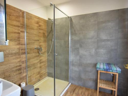 a shower with a glass door in a bathroom at House with private beach by the lake, whirlpool in Nadole