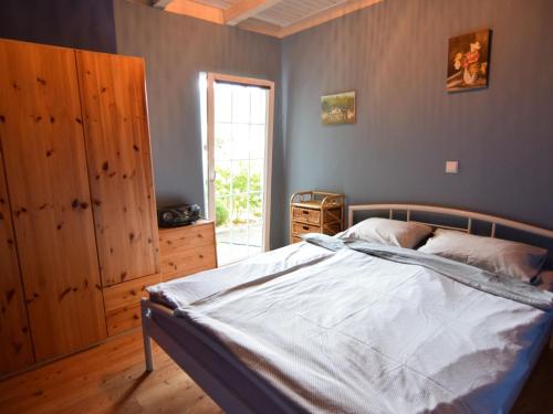 a bedroom with a bed and a window at House with private beach by the lake, whirlpool in Nadole