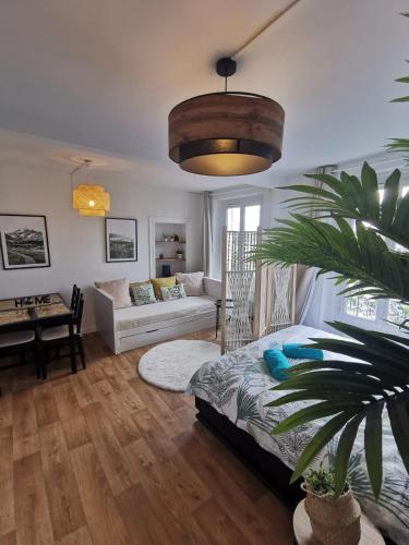 un salon avec un lit et un canapé dans l'établissement Charmant studio à Montmorency, à Montmorency
