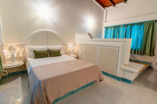 a bedroom with a large bed with a white bedspread at Hotel Cocoliso Island Resort in Isla Grande