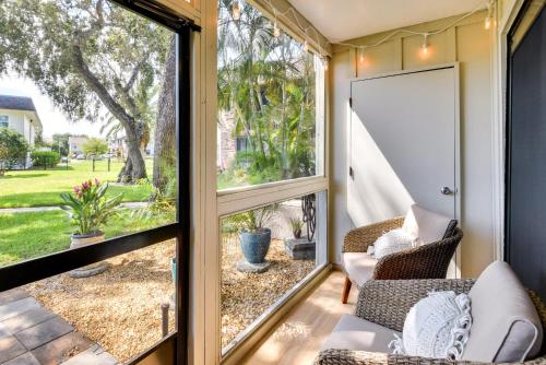 a screened in porch with a view of a yard at New Smyrna Beach Condo Pool Access, Walk to Beach in New Smyrna Beach
