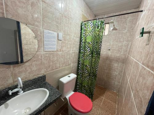 a bathroom with a toilet and a sink and a shower at Canto da Liberdade in Boa Vista