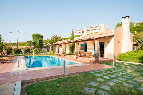 a house with a swimming pool in a yard at Villa Givera in Giannoudi