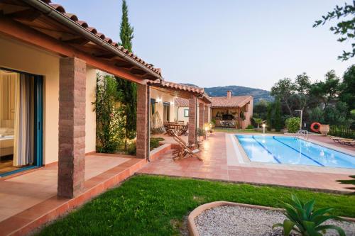 a house with a swimming pool in a yard at Villa Givera in Giannoudi