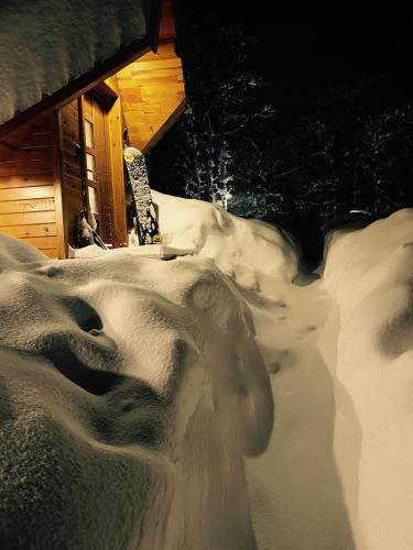 a snowboard sitting on top of a pile of snow at Vila Sun forest in Žabljak