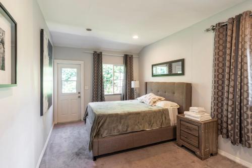 a bedroom with a bed and a dresser with a night stand at Charming Duplex Home in Sherman Oaks in Los Angeles
