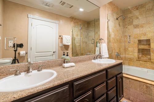 a bathroom with two sinks and a large mirror at Charming Duplex Home in Sherman Oaks in Los Angeles