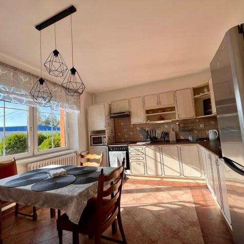 a kitchen and dining room with a table and chairs at Apartmán Cimca in Cheb
