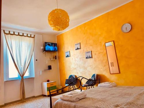 a bedroom with a bed and a window and two chairs at La Casina di Isola in Livorno
