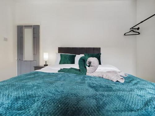 a bedroom with a bed with towels on it at Birks House By RMR Accommodations - NEW - Sleeps 8 - Modern - Parking in Stoke on Trent