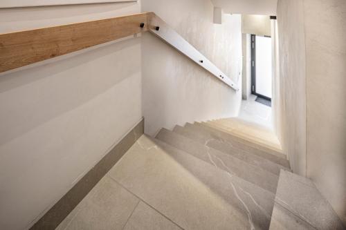 an empty room with stairs and a window at VI&LA - Apart House in Piešťany