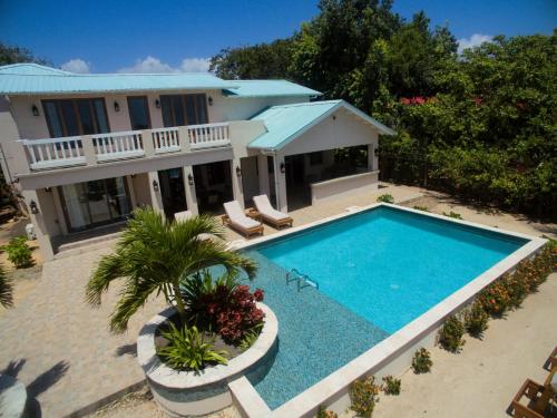 an aerial view of a house with a swimming pool at Large Ocean Front Home Close to Village - Surfside Gecko in Seine Bight Village