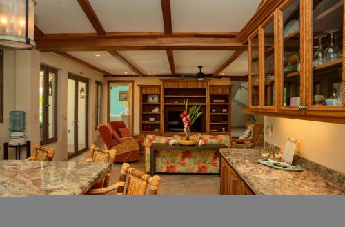 a living room with a couch and a table at Large Ocean Front Home Close to Village - Surfside Gecko in Seine Bight Village