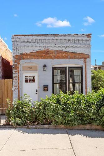a brick building with a white door and a window at Stylish Uptown Butte Condo -634 in Butte