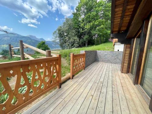 a wooden deck on the side of a house at Chalet rénové 2-4 pers, terrasses, vue Mont Charvin - FR-1-505-187 in Crest-Voland