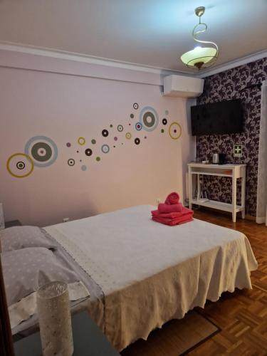 a bedroom with a bed and a wall with planets at Sleep and Fly in Faro