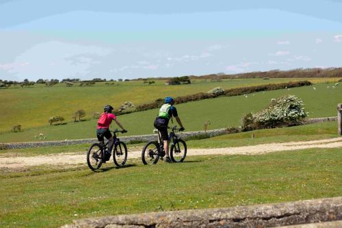two people riding bikes on a grassy field at Sleep Hotel in Worthing