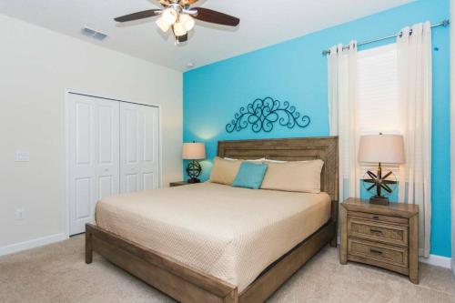 a bedroom with a bed and a ceiling fan at Modern Vacation Home with Private Pool CG1593 in Davenport