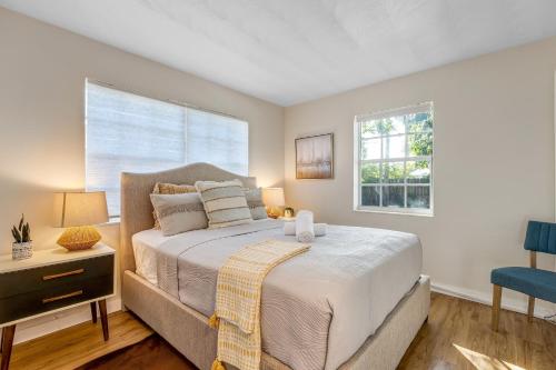 a bedroom with a large bed and a window at Tropical getaway with coastal charm in Pompano Beach