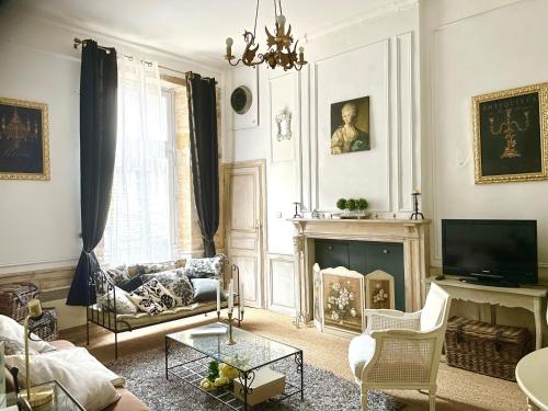 a living room with a couch and a fireplace at Caporizon-Sarlat l'élégance-T2 Plein centre cité médiévale in Sarlat-la-Canéda
