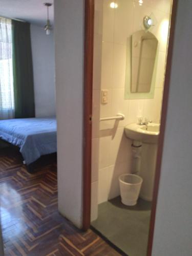 a room with a bathroom with a sink and a mirror at Samadri in Arequipa