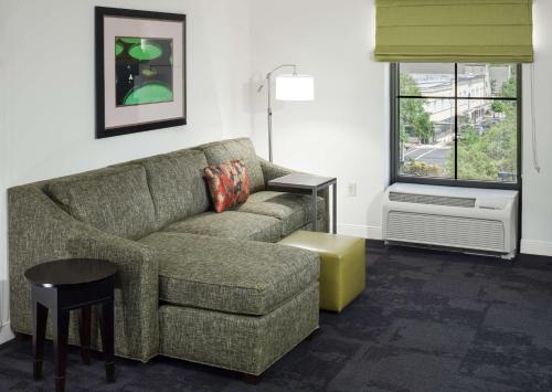 a living room with a couch and a window at Hampton Inn & Suites Gainesville Downtown in Gainesville